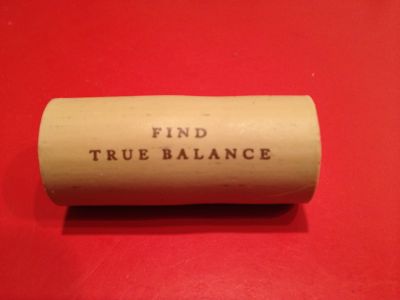 Wine cork that says "Find true balance"