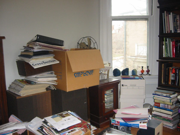 Messy home office with piles