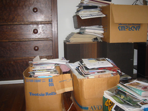 Boxes and piles of magazines and documents