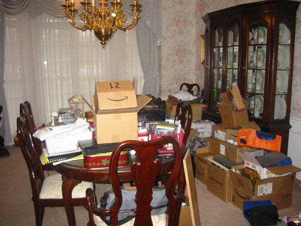 Unusable dining area, stacked with boxes